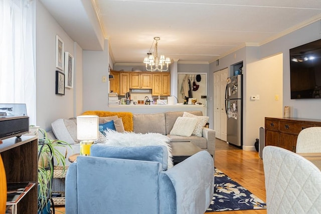 280 Harvard St Unit 1A, Cambridge, MA 02139 - living area with a chandelier, ornamental molding, baseboards, and light wood finished floors