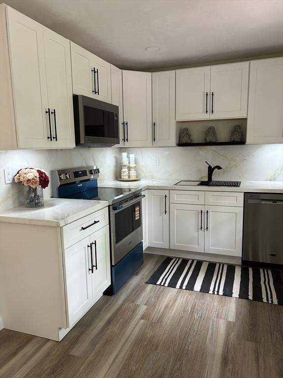 61 Esta Rd, Plymouth, MA 02360 - kitchen with stainless steel appliances, dark wood-style flooring, light countertops, and white cabinets