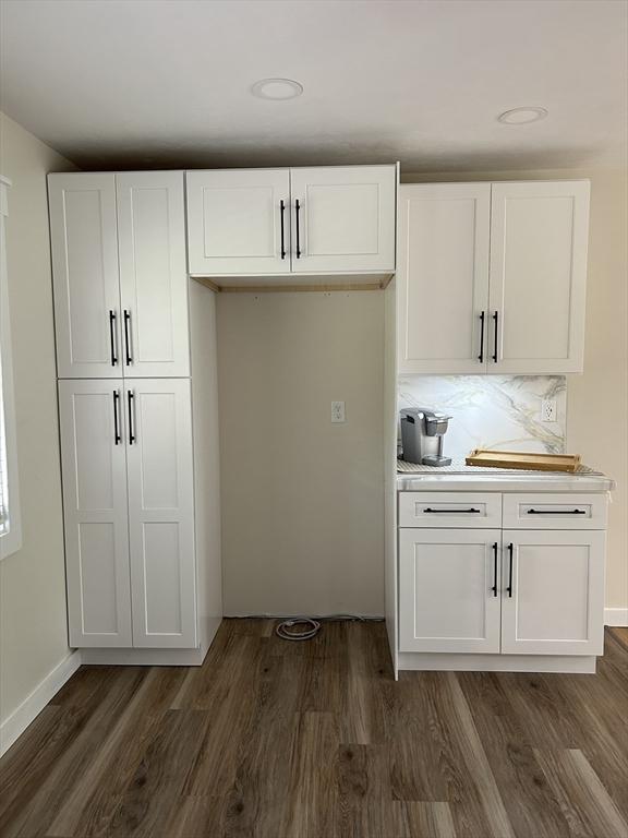 61 Esta Rd, Plymouth, MA 02360 - kitchen featuring dark wood-style flooring, white cabinetry, light countertops, and decorative backsplash