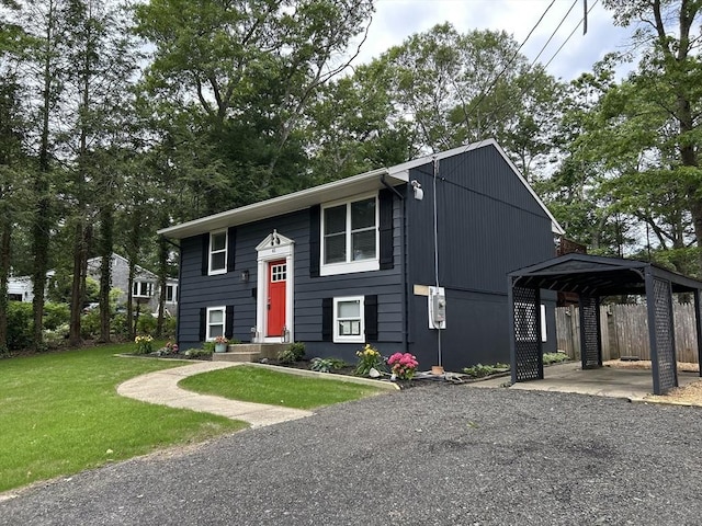 61 Esta Rd, Plymouth, MA 02360 - view of front of house featuring a front lawn, a detached carport, and driveway