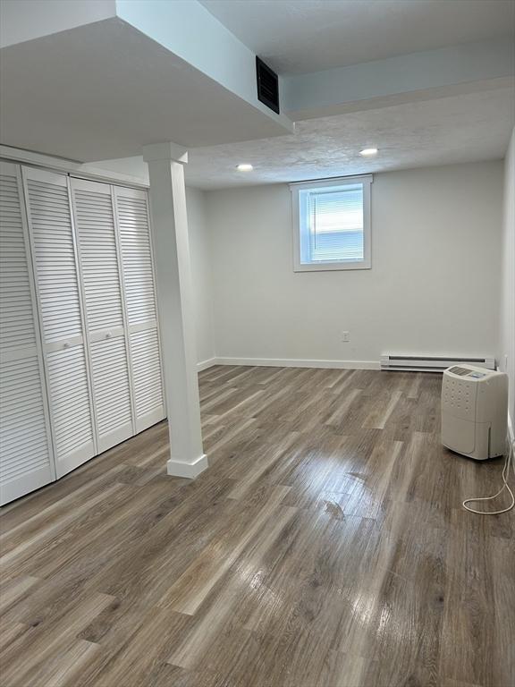 61 Esta Rd, Plymouth, MA 02360 - basement featuring a baseboard heating unit and wood finished floors