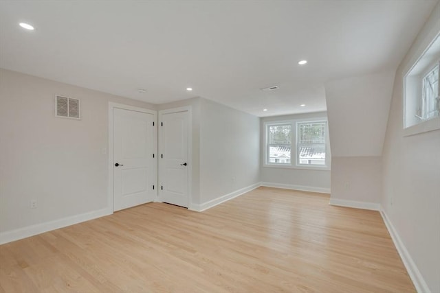 empty room featuring visible vents, recessed lighting, light wood-style flooring, and baseboards