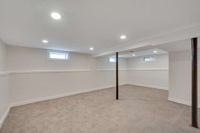 below grade area featuring carpet floors, recessed lighting, baseboards, and a wealth of natural light
