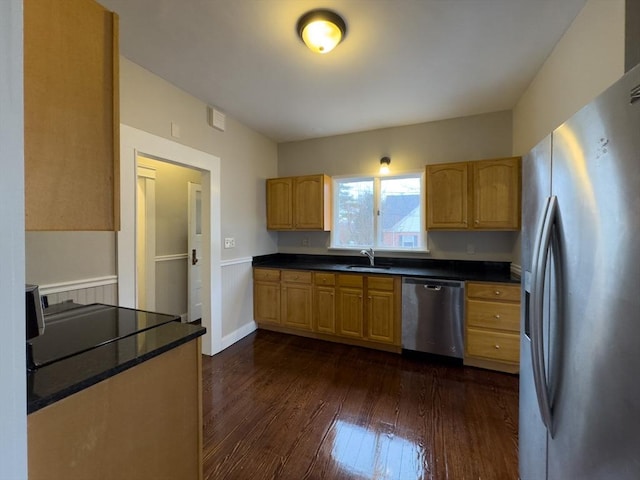 kitchen featuring dark hardwood / wood-style flooring, sink, and stainless steel appliances