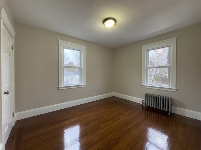 bonus room with radiator and dark wood-type flooring