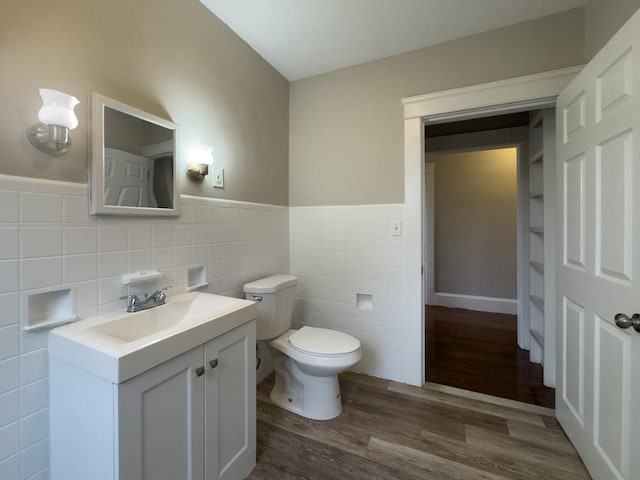 bathroom with vanity, hardwood / wood-style floors, tile walls, and toilet