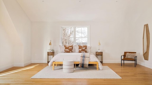 bedroom featuring baseboards and wood finished floors