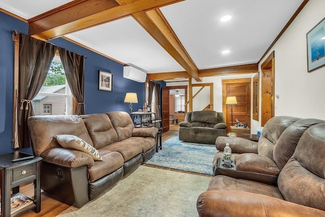 living room with ornamental molding, beamed ceiling, and hardwood / wood-style floors