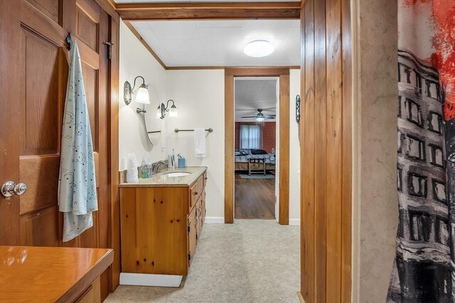 bathroom featuring ornamental molding, vanity, and ceiling fan