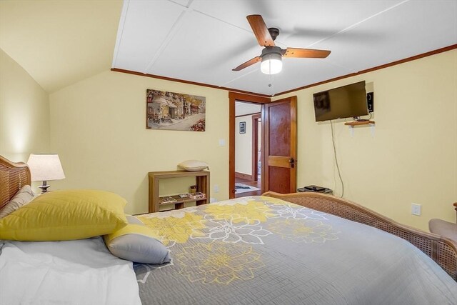 bedroom featuring vaulted ceiling, ceiling fan, and crown molding