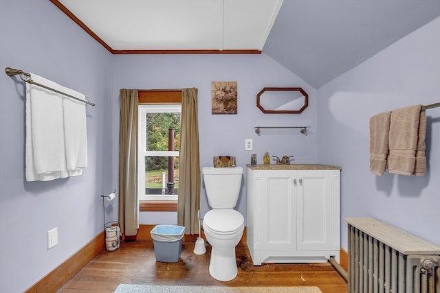 bathroom featuring radiator heating unit, wood-type flooring, lofted ceiling, and toilet