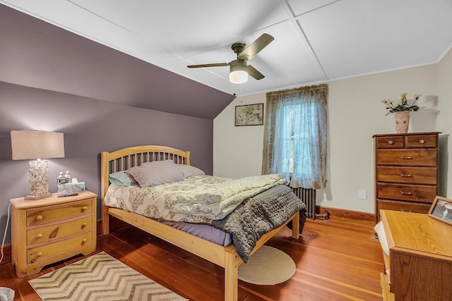 bedroom featuring light wood-type flooring, lofted ceiling, and ceiling fan