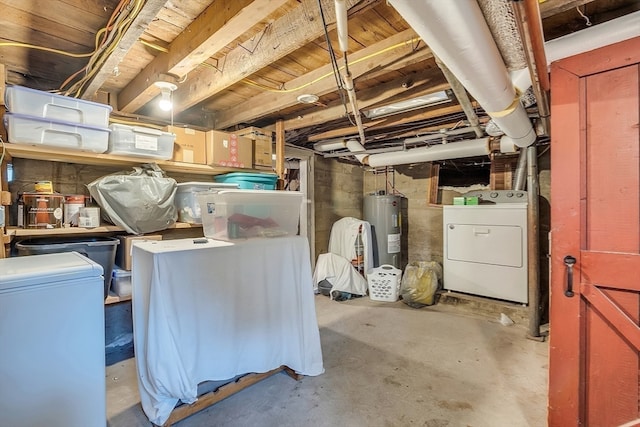 basement featuring electric water heater and independent washer and dryer