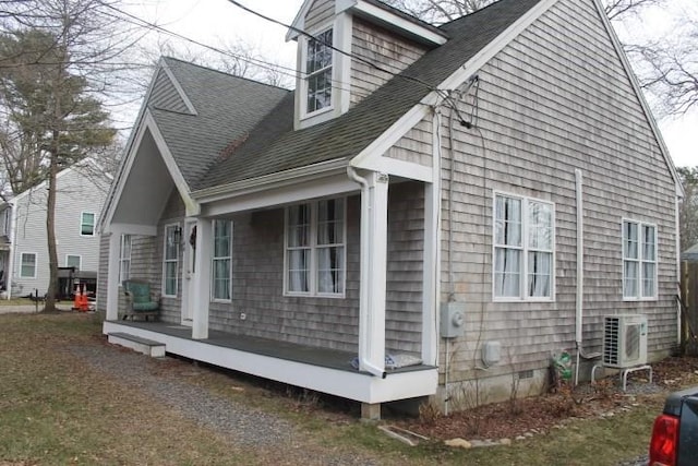 view of side of property with a porch and ac unit