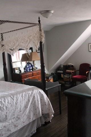 bedroom with dark wood-type flooring