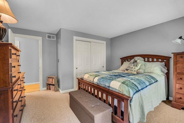 bedroom with light carpet and a closet