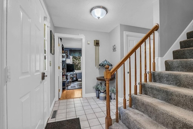 foyer featuring light tile patterned floors