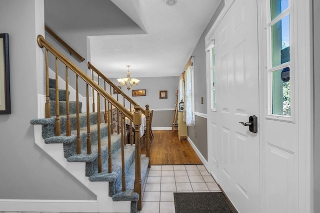 entrance foyer featuring light tile patterned floors and a notable chandelier