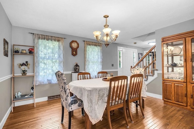 dining room featuring a chandelier and hardwood / wood-style flooring