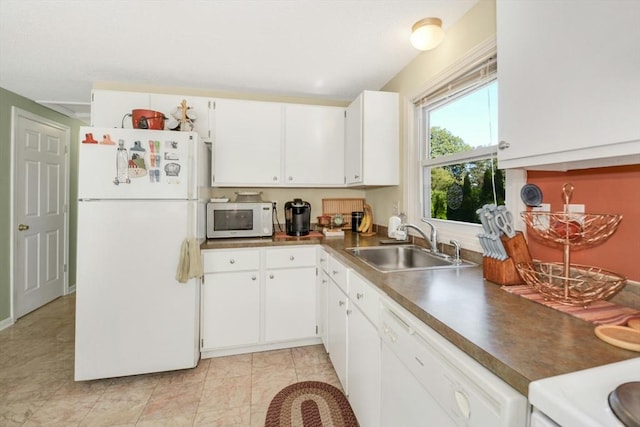 kitchen featuring white appliances, a sink, white cabinetry, and dark countertops