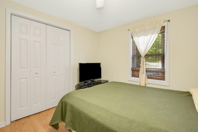 bedroom with a closet and wood finished floors