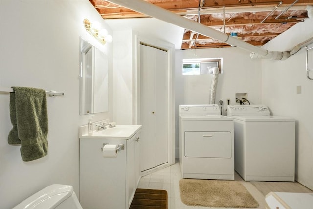 laundry area featuring washing machine and dryer and light tile patterned floors