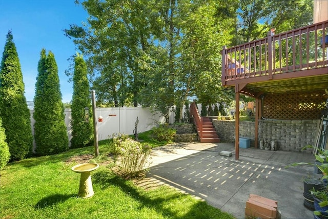 view of yard featuring a patio, stairway, and a wooden deck