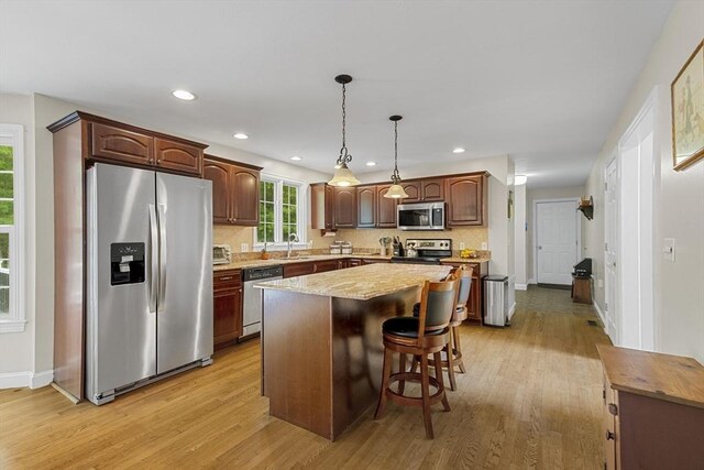 53 Arnold Way, Uxbridge, MA 01569 - kitchen featuring appliances with stainless steel finishes, light wood-style flooring, a center island, pendant lighting, and recessed lighting