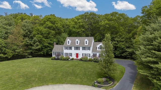 53 Arnold Way, Uxbridge, MA 01569 - view of front of home with a forest view, a front yard, a chimney, and an outbuilding