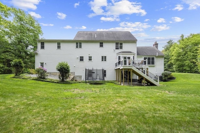 53 Arnold Way, Uxbridge, MA 01569 - rear view of house with stairway, a deck, a yard, a trampoline, and a chimney