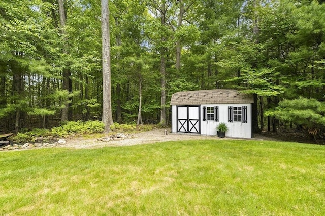 53 Arnold Way, Uxbridge, MA 01569 - view of green lawn with a storage unit and a forest view