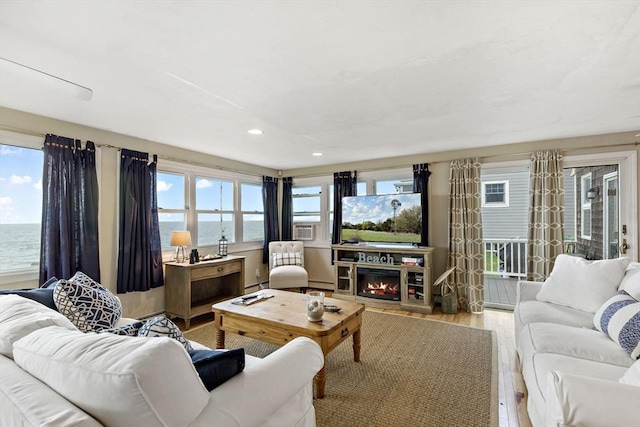 125 Seaview Dr, Plymouth, MA 02360 - living area featuring recessed lighting, plenty of natural light, a glass covered fireplace, and wood finished floors