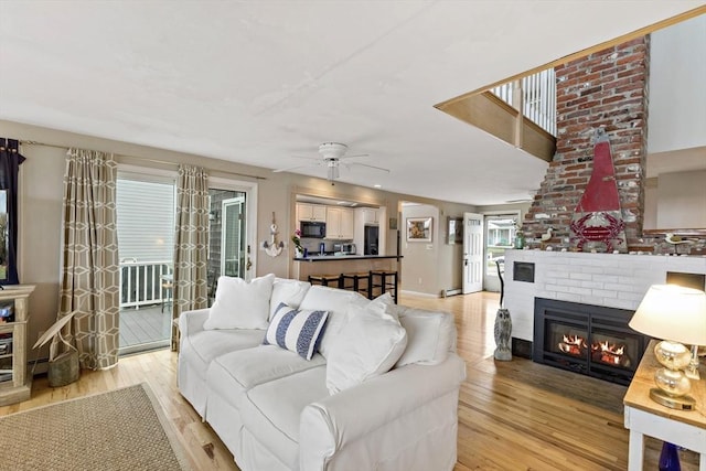 125 Seaview Dr, Plymouth, MA 02360 - living area featuring ceiling fan, baseboards, light wood-style flooring, and a fireplace