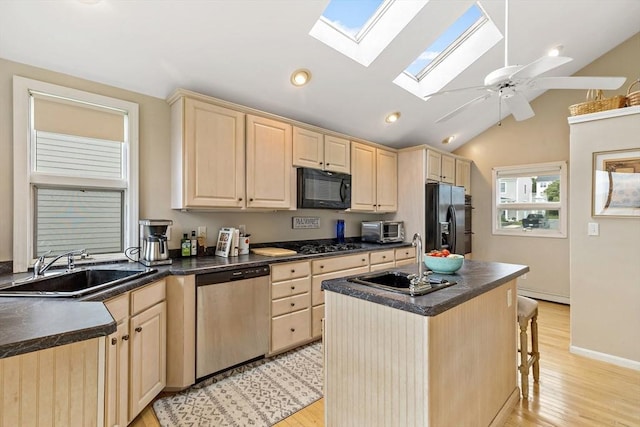 125 Seaview Dr, Plymouth, MA 02360 - kitchen with a sink, dark countertops, black appliances, and light brown cabinets