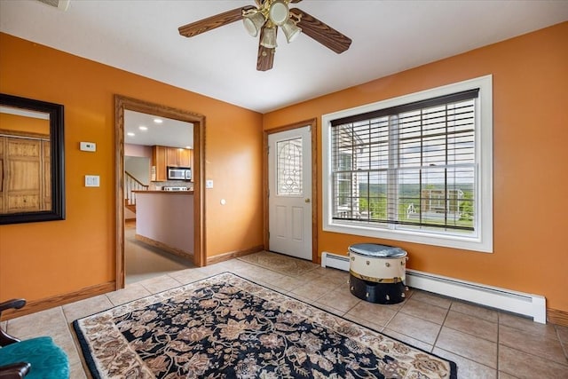 447 Coy Hill Rd, Warren, MA 01083 - entrance foyer featuring a baseboard heating unit, light tile patterned floors, and baseboards