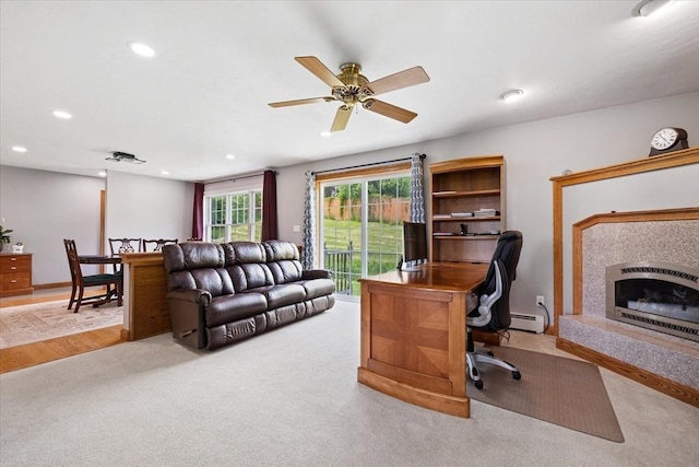 447 Coy Hill Rd, Warren, MA 01083 - home office with baseboard heating, a fireplace with raised hearth, recessed lighting, ceiling fan, and carpet
