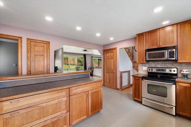 447 Coy Hill Rd, Warren, MA 01083 - kitchen with stainless steel appliances, backsplash, dark countertops, recessed lighting, and brown cabinets