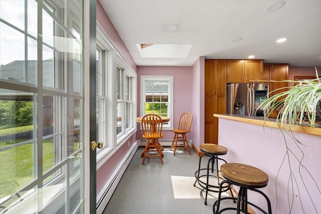 447 Coy Hill Rd, Warren, MA 01083 - kitchen featuring stainless steel refrigerator with ice dispenser, brown cabinetry, a skylight, a baseboard radiator, and baseboards