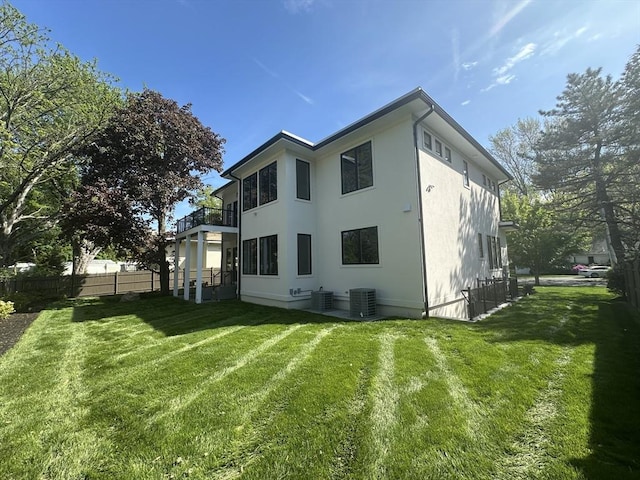 55 June Ln, Newton, MA 02459 - back of property with a balcony, stucco siding, and central AC