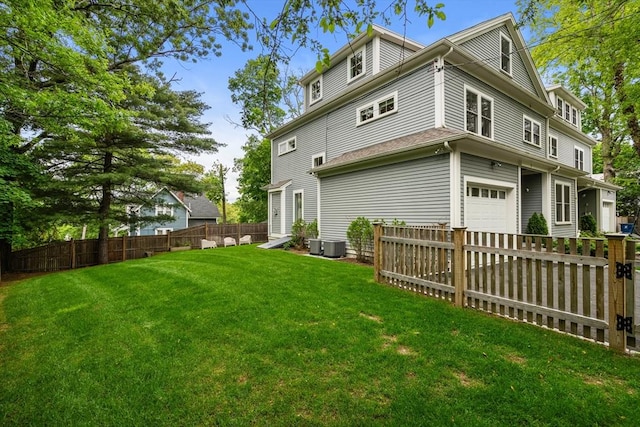 2 Rockwood Ter Unit 2, Newton, MA 02466 - back of property with an attached garage and central AC unit