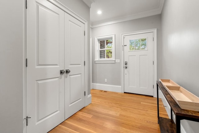 2 Rockwood Ter Unit 2, Newton, MA 02466 - entrance foyer with baseboards, crown molding, and light wood-style flooring