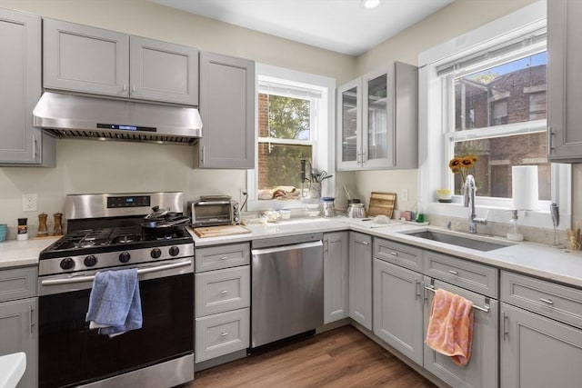 130 Glenville Ave, Boston, MA 02134 - kitchen with stainless steel appliances, under cabinet range hood, gray cabinetry, light countertops, and recessed lighting