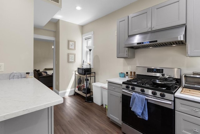 130 Glenville Ave, Boston, MA 02134 - kitchen with stainless steel range with gas cooktop, under cabinet range hood, gray cabinets, dark wood-style floors, and recessed lighting