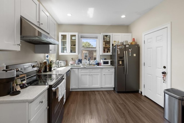 130 Glenville Ave, Boston, MA 02134 - kitchen with stainless steel appliances, under cabinet range hood, light countertops, dark wood-style flooring, and recessed lighting