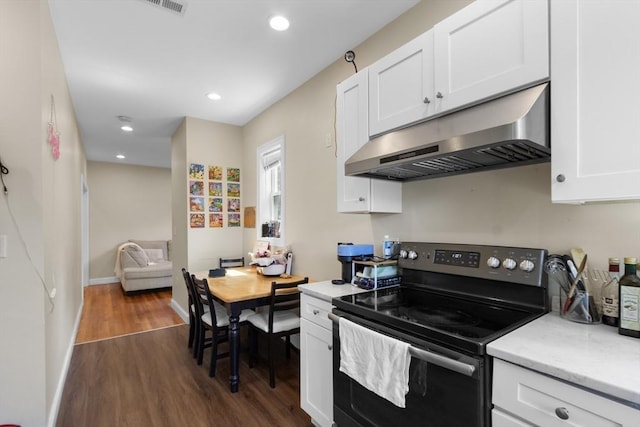130 Glenville Ave, Boston, MA 02134 - kitchen featuring stainless steel range with electric cooktop, under cabinet range hood, dark wood-style floors, white cabinets, and light stone countertops