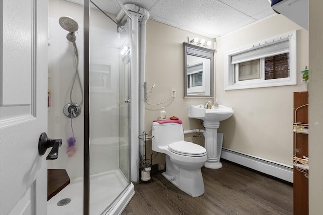 130 Glenville Ave, Boston, MA 02134 - bathroom with a baseboard heating unit, a shower stall, wood finished floors, and a drop ceiling