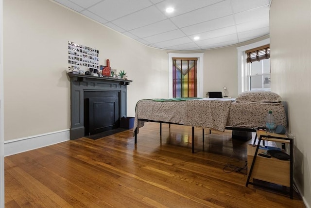 130 Glenville Ave, Boston, MA 02134 - dining space with hardwood / wood-style flooring, a fireplace with flush hearth, healthy amount of natural light, and a drop ceiling