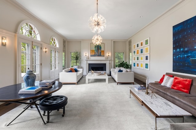 living room featuring an inviting chandelier and ornamental molding