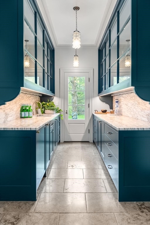 interior space with backsplash, decorative light fixtures, light tile flooring, and crown molding