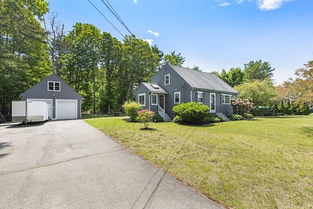 7 Cornish St, Carver, MA 02330 - view of front facade featuring a detached garage, an outdoor structure, a front lawn, and view of wooded area